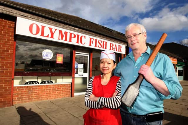 Ray Critchlow and his wife with the paddle they used to beat off the robbers.