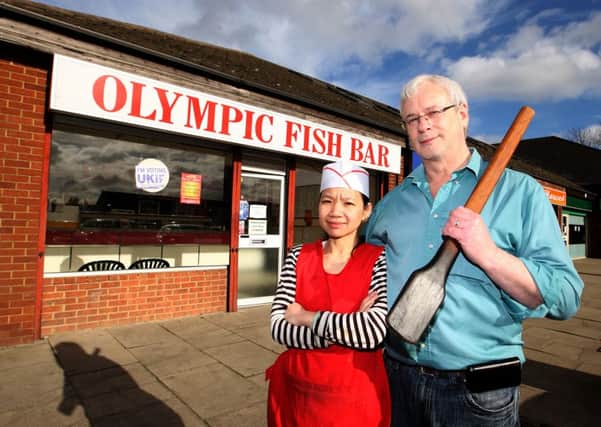Ray Critchlow and his wife with the paddle they used to beat off the robbers.