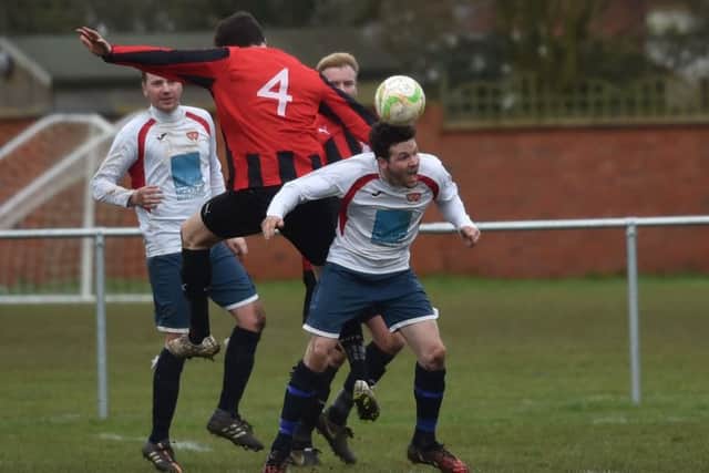 Action from the 2-2 draw between ON Chenecks and Raunds Town in Division One. Pictures by Dave Ikin