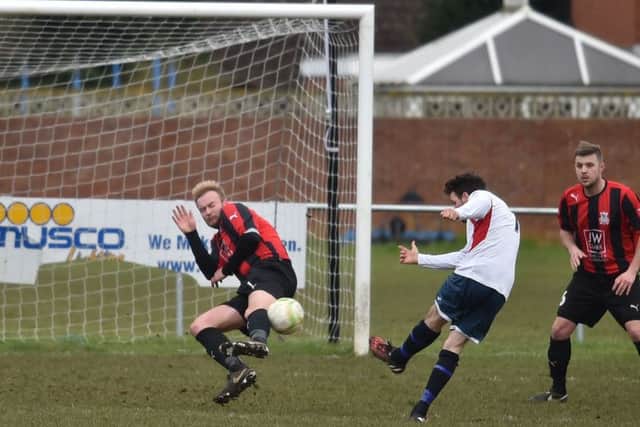 Action from the 2-2 draw between ON Chenecks and Raunds Town in Division One. Pictures by Dave Ikin