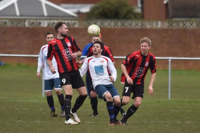 Action from the 2-2 draw between ON Chenecks and Raunds Town in Division One. Pictures by Dave Ikin