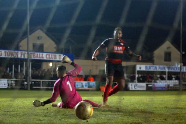Rene Howe scores Kettering Town's third goal, which wrapped up the midweek success over Dorchester Town at Latimer Park. Picture by Peter Short