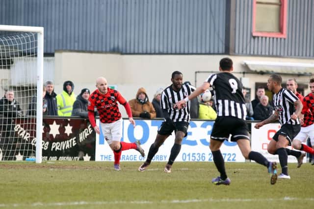 Greg Mills shapes up to shoot and score for Corby Town against Nuneaton Town
