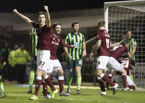 BIG MOMENT - Luke Prosser and Ricky Holmes celebrate after John-Joe O'Toole fired the Cobblers ahead against AFC Wimbledon (Picture: Kirsty Edmonds)