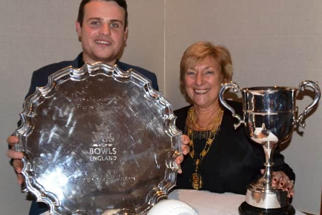 Jamie Walker with his array of trophies that he collected at the Bowls England presentation evening along with the organisations 2015 president Marcia Dunstone