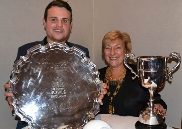 Jamie Walker with his array of trophies that he collected at the Bowls England presentation evening along with the organisations 2015 president Marcia Dunstone