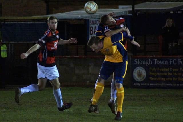 Brett Solkhon heads away the danger during Kettering Town's 3-1 victory at Slough Town on Tuesday. Pictures by Peter Short