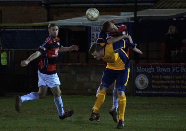 Brett Solkhon heads away the danger during Kettering Town's 3-1 victory at Slough Town on Tuesday. Pictures by Peter Short