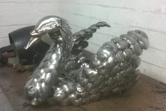A swan made with spoons by sculptor Mark Thompson