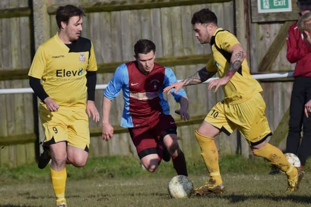 Action from Raunds Town's 4-0 defeat at Long Buckby in UCL Division One last weekend. The Shopmates take on promotion-chasing Stewarts & Lloyds tomorrow. Picture by Dave Ikin