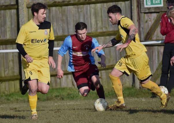 Action from Raunds Town's 4-0 defeat at Long Buckby in UCL Division One last weekend. The Shopmates take on promotion-chasing Stewarts & Lloyds tomorrow. Picture by Dave Ikin