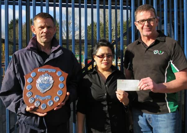 A total of Â£200 raised at the Barry Scholes Memorial Shield event in Corby has been handed over to the Lakelands Hospice