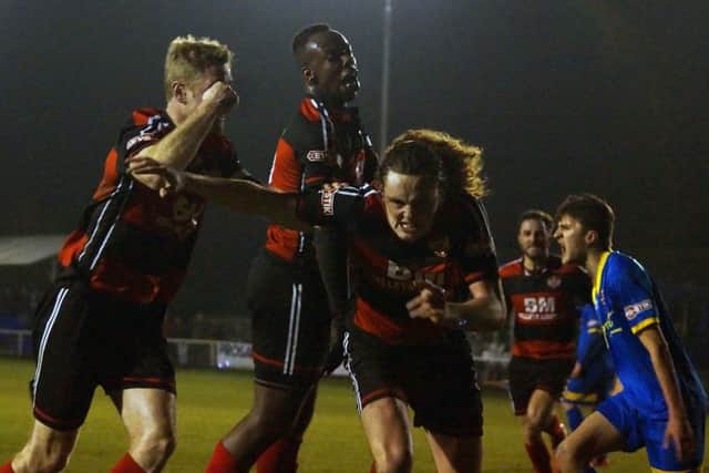 Liam Canavan heads off to celebrate after he scored Kettering Town's opening goal late on against Paulton Rovers on Tuesday night. Picture by Peter Short