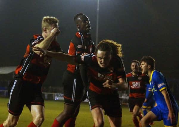 Liam Canavan heads off to celebrate after he scored Kettering Town's opening goal late on against Paulton Rovers on Tuesday night. Picture by Peter Short