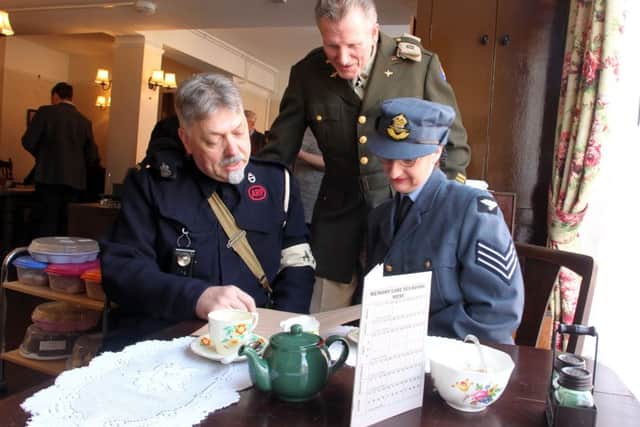 ARP Warden Peter Horn, USAAF Cpt Mick Hart and WAAF radio op Tracy Morris having tea at the new tearoom