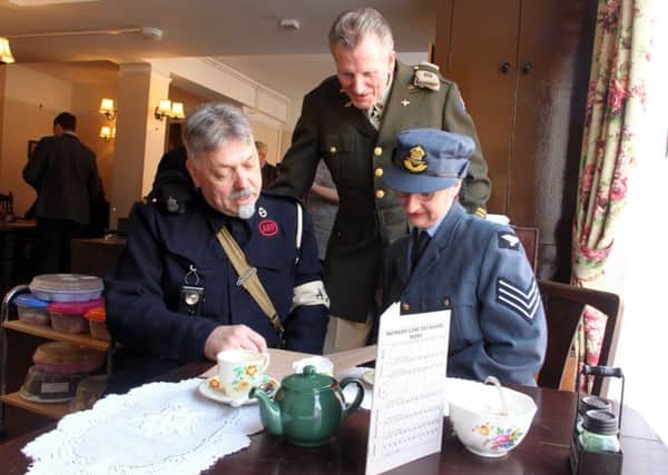 ARP Warden Peter Horn, USAAF Cpt Mick Hart and WAAF radio op Tracy Morris having tea at the new tearoom