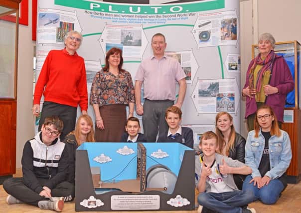 For the last 12 months 30 young people from Corby  Team PLUTO - have been piecing together part of their heritage - the story of PLUTO  how Corby men and women helped win the Second World War. PLUTO is an acronym for Pipe Line Under The Ocean.
 
Corby produced 1,000 miles of flexible steel pipe that after being coiled on a conundrum (seen here in model form on the floor) was laid off (in complete secrecy) onto the bed of the English Channel. PLUTO supplied a million gallons of fuel on a daily basis to 55,000 allied vehicles.
 
Different groups of young people have travelled to the Isle of Wight, London and around Corby to tell the full story in 10 video podcasts, an exhibition, a model and a song.