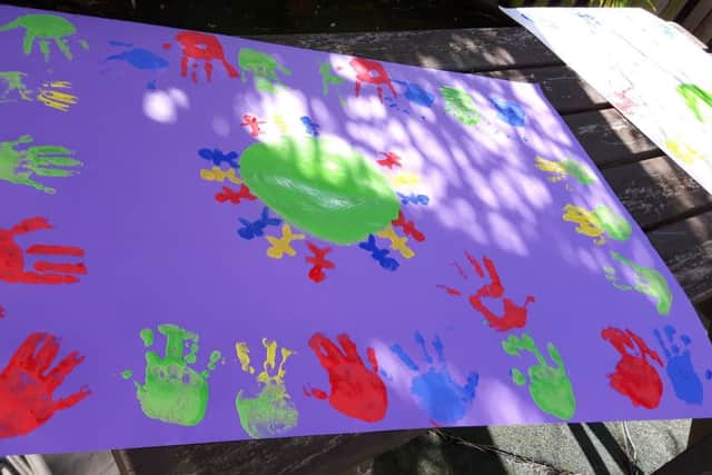 RALLYING CRY: Banner painting ahead of the children's centre cuts rally NNL-160104-113327001