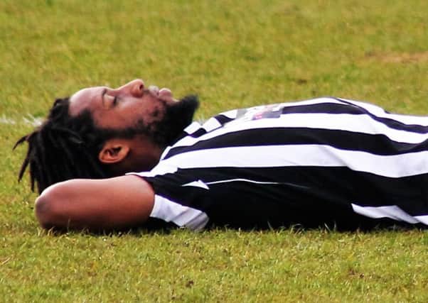 Anton Brown cuts a dejected figure after Corby Town's last-gasp 3-2 defeat to Alfreton Town. Picture by David Tilley