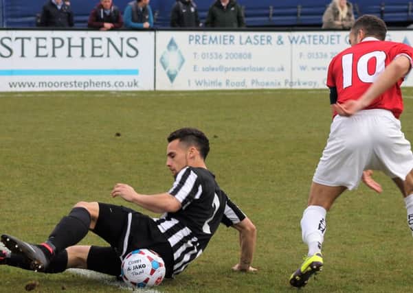 Ellis Myles challenges Jerome Wright during Corby Town's 3-2 defeat to FC United of Manchester. Picture by David Tilley