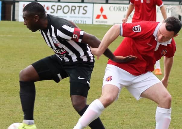 Corby Town captain Cleveland Taylor battles for possession during Saturday's 3-2 home defeat to FC United of Manchester. Picture by David Tilley