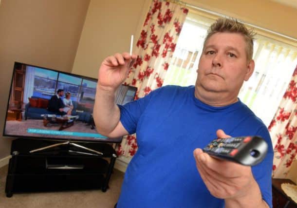 Thomas Defty with his new television after his old set was damaged by smoke according to Panasonic.