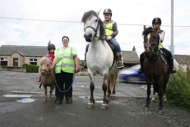 Joann Pollock complaining that drivers have no idea how to act when passing horses on the road. Lucy Corroon (7) on Halle; Lauren Hamilton on Merlin; Sophie Corroon (10) on Coco. NNL-160413-113707001