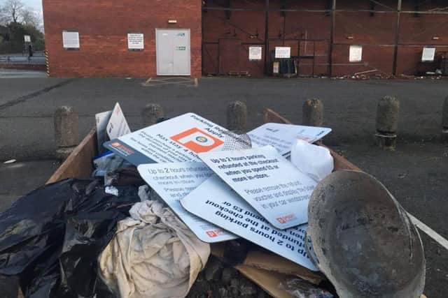A skip showing the old signs at the Co-op car park in Corby, with new signs in the background NNL-160415-140304001