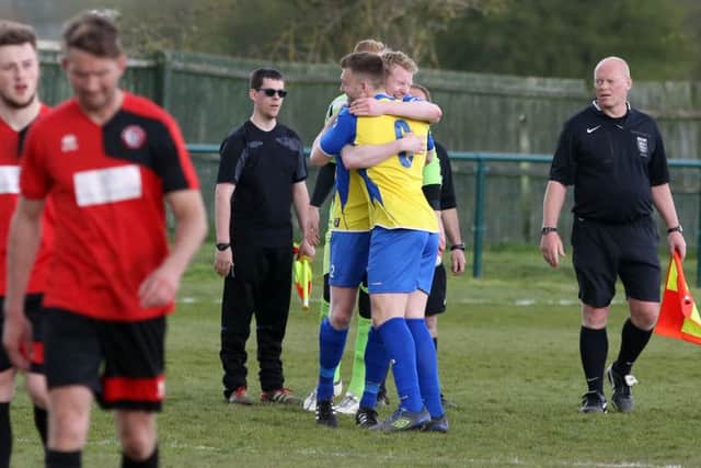 Wellingborough Town's players celebrate after securing their UCL Premier Division status on the last weekend of the season. Pictures by Alison Bagley
