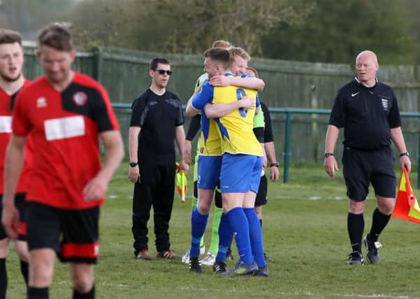 Wellingborough Town's players celebrate after securing their UCL Premier Division status on the last weekend of the season. Pictures by Alison Bagley