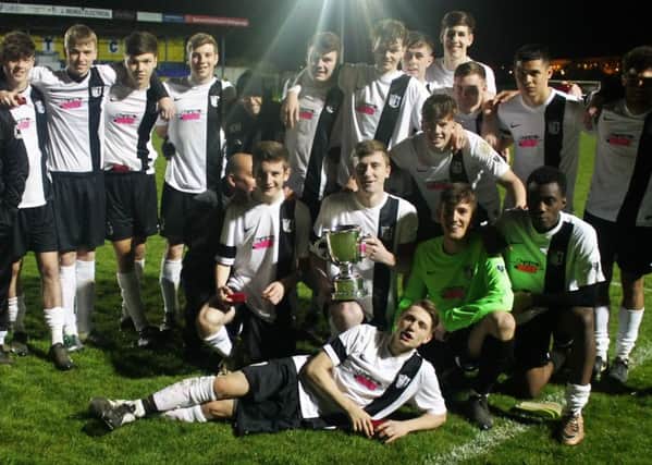 Corby Town's youth team celebrate after they were crowned overall Northants Senior Youth League champions on Tuesday night. Picture by David Tilley