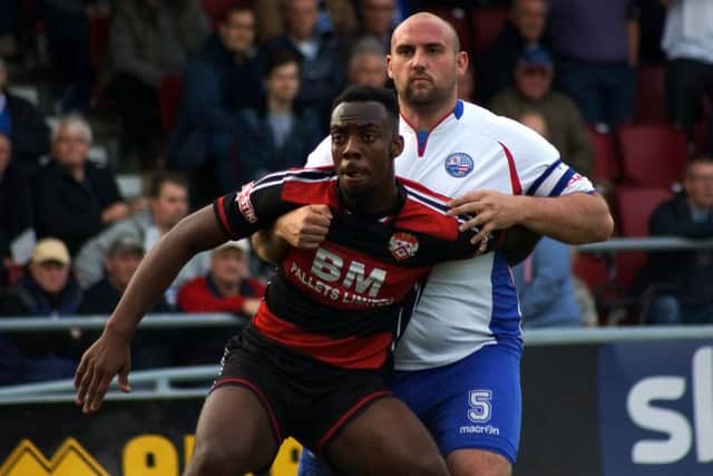 Kettering striker Silvano Obeng gets to grips with Diamonds captain Liam Dolman