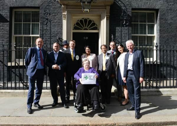 Dora Shergold hands in the petition at 10 Downing Street.