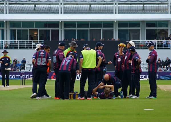 Northamptonshire bowler Olly Stone receives treatment after suffering what has proved to be a season-ending knee injury during last week's T20 Blast win over Worcestershire