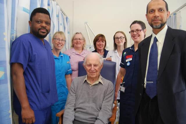 George Saxby surrounded by the team caring for him on Barnwell B ward where he has been recovering from his surgery