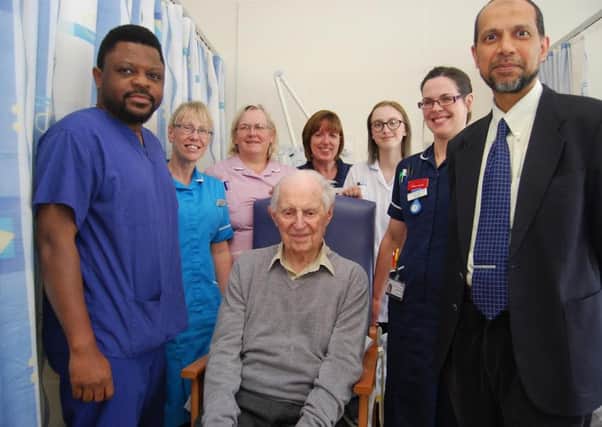 George Saxby surrounded by the team caring for him on Barnwell B ward where he has been recovering from his surgery