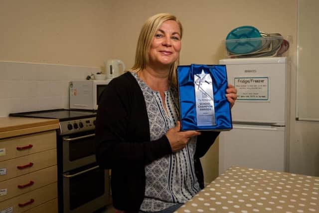 Sarah Cresswell with her award in the creative room at Gretton Primary School