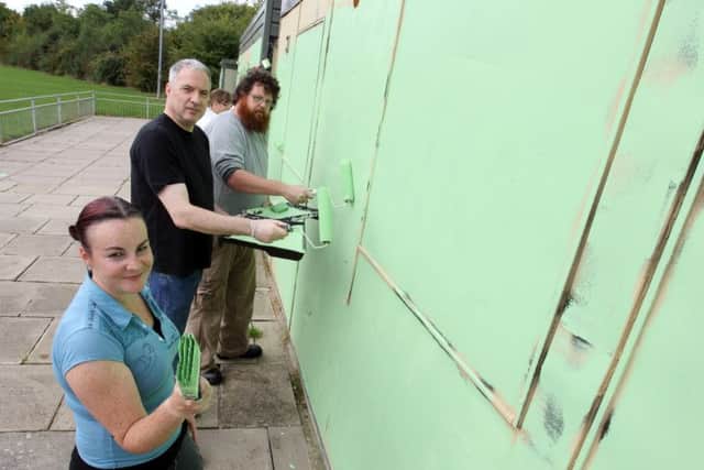 Volunteers helped paint over the racist graffiti at the club
