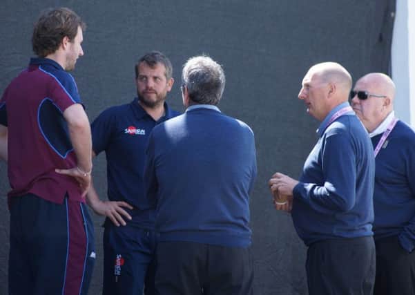 Alex Wakely (left) chats with the officials at umpires at Chesterfield ahead of the abandoned T20 clash on Sunday