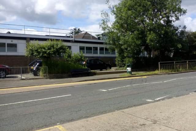 The bus shelter has been removed, with the gap left bricked up.