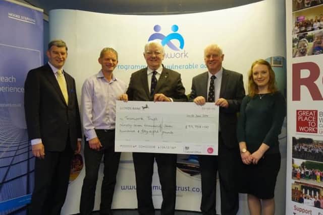 The Teamwork Trust being presented with their cheque.