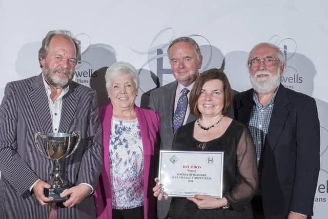 Helmdon - Overall 2016 Best Village Competition winner and winner of the medium sized villages cup. Photo shows villagers Ross Vicars, Sarah Adhemar & John Coatsworth  receiving the cup from Annette & Paul Hollowell, sponsors of the competition.