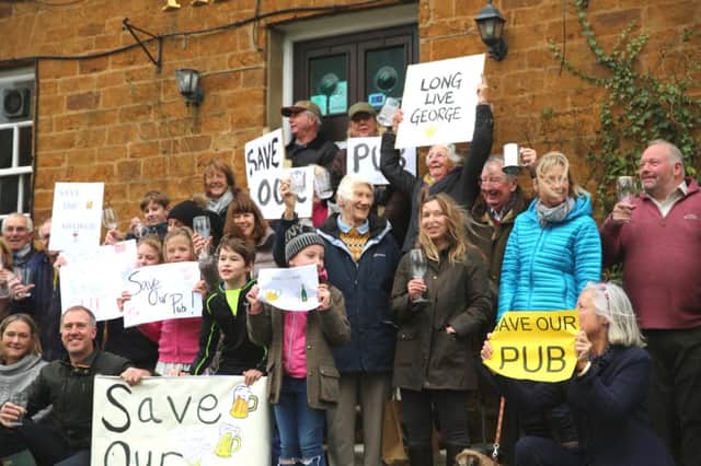 Villagers protesting outside the pub in December last year.