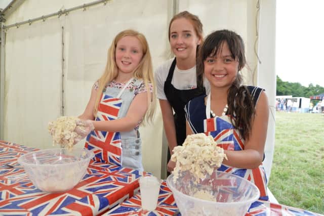 Centre, Natalie Smith with Emily Ellis 10 and Rayne Bahri 8 make freckle bread during the junior bake off.
PICTURE: ANDREW CARPENTER