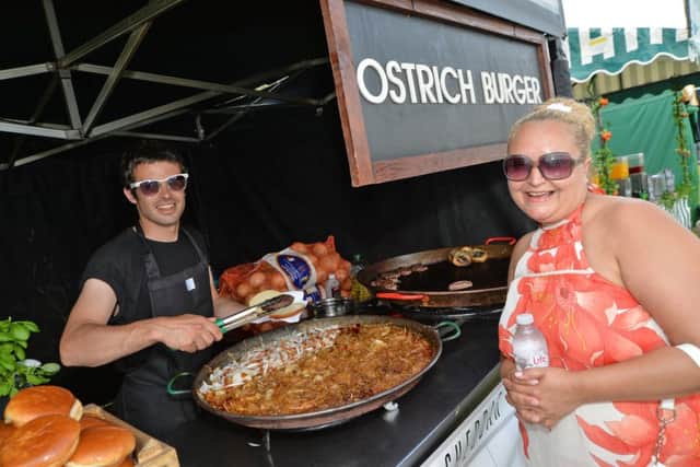Dan Wilkinson serves Debbie Mohomed a ostrich burger during the festival.
PICTURE: ANDREW CARPENTER