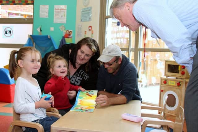 Sir Tony Hawkhead talks to Wellingborough parents Paul and Lisa and little ones Roxy and Jessica