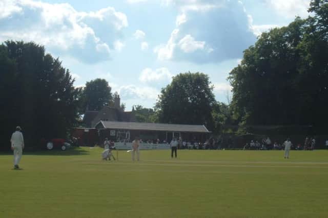 Action from Weekley and Warkton Cricket Club, with their current pavilion in the background.