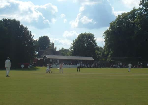 Action from Weekley and Warkton Cricket Club, with their current pavilion in the background.