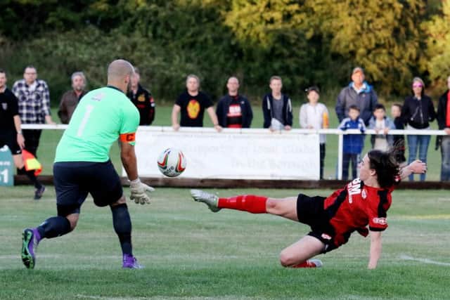 Leamington goalkeeper Tony Breeden comes to collect the ball as Kettering's Ben Stephens stretches to reach it