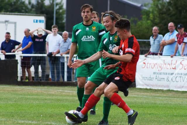 Kettering's Callum Westwood challenges Hitchin's Matt Lench during the goalless draw